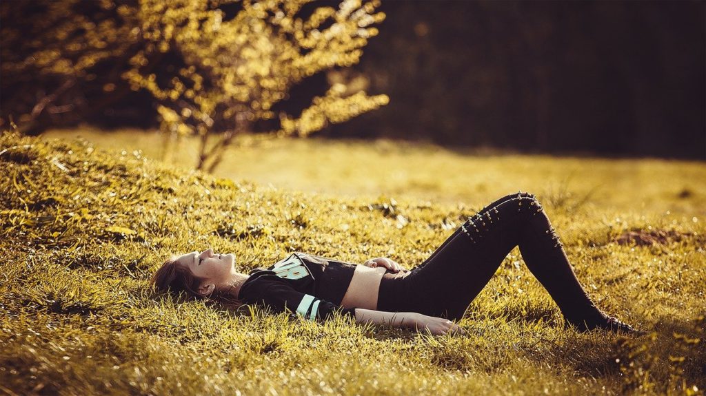 girl lying on the grass 1741487 1280